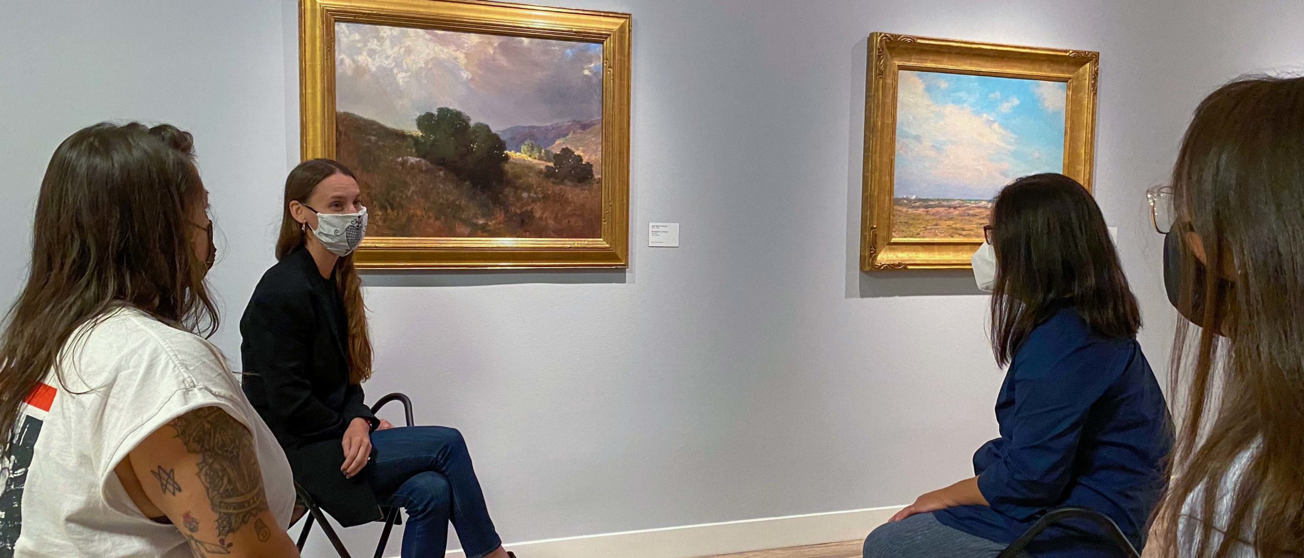 Erin Stout image of a curator speaking with some visitors