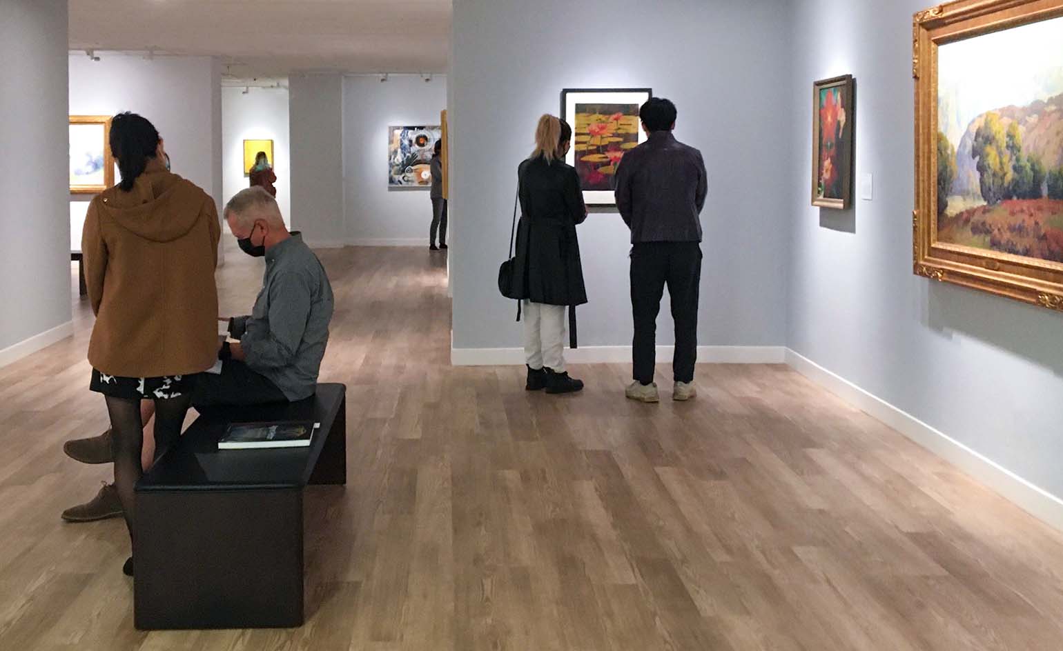 Museum visitors looking at art