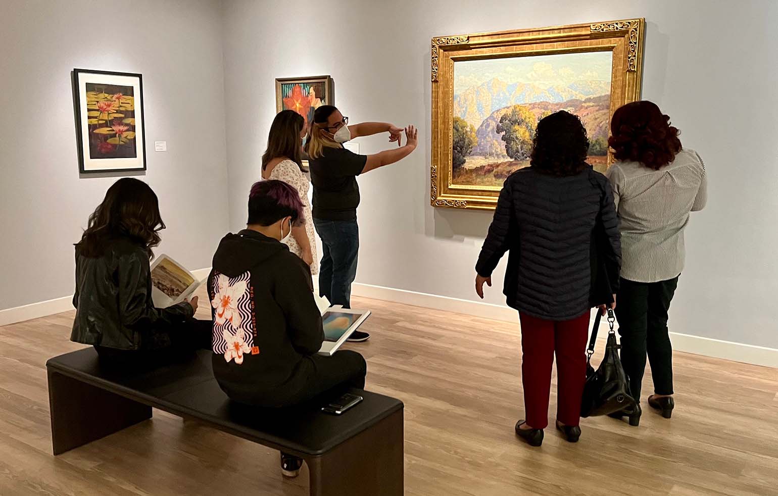 visitors looking at a painting on view at Langson IMCA