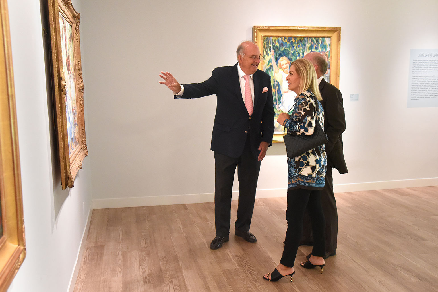 Visitors discussing art exhibit