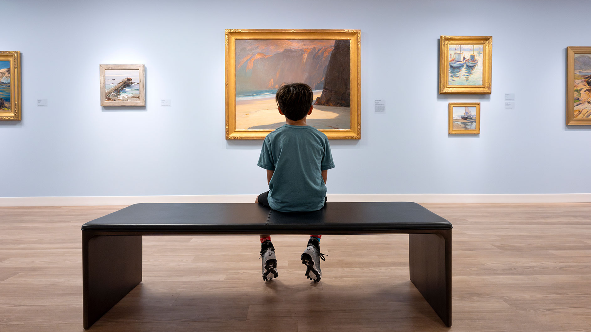 Child looking at painting in an exhibit