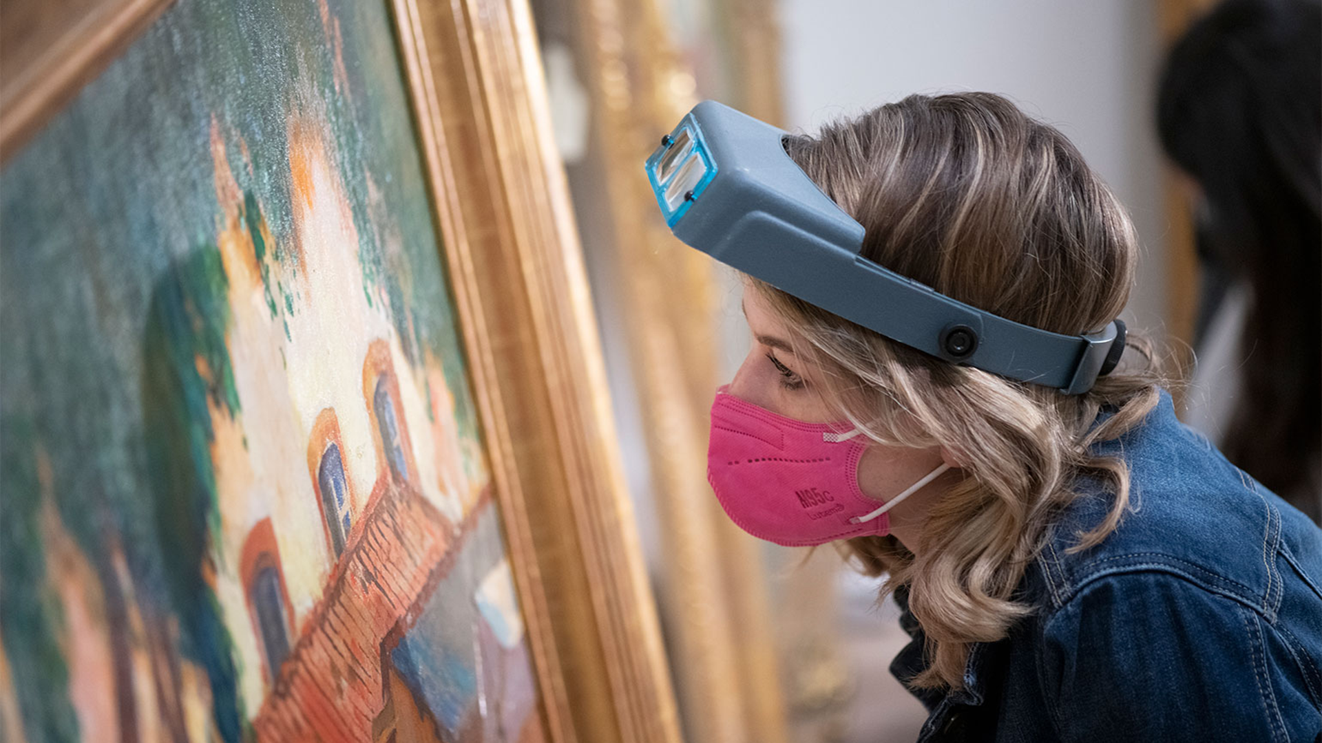 Art conservator examining a painting