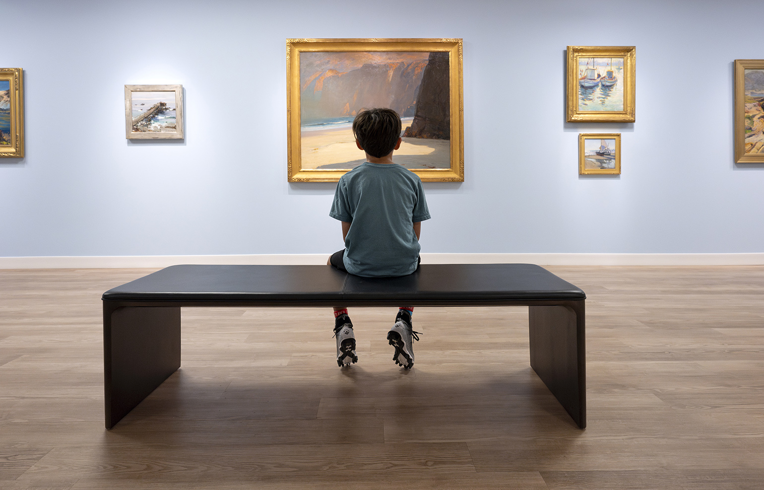 Child looking at painting in an exhibit